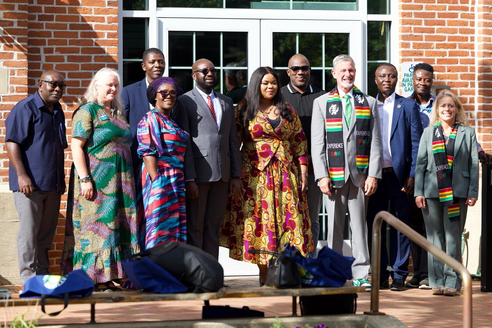 A group photo of delegates outside a campus building